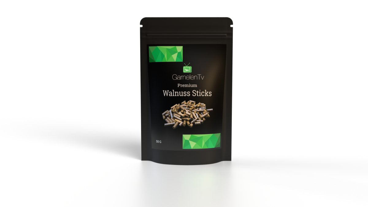 Premium Walnuss Sticks 50g in a black packaging, perfect for aquatic pets.